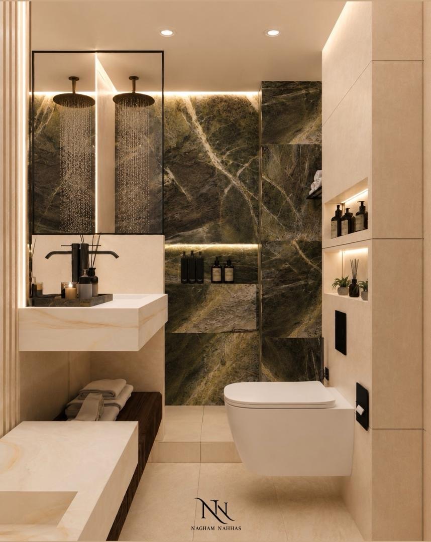 Bathroom with a green marble shower wall, twin rain heads and lit stone niches