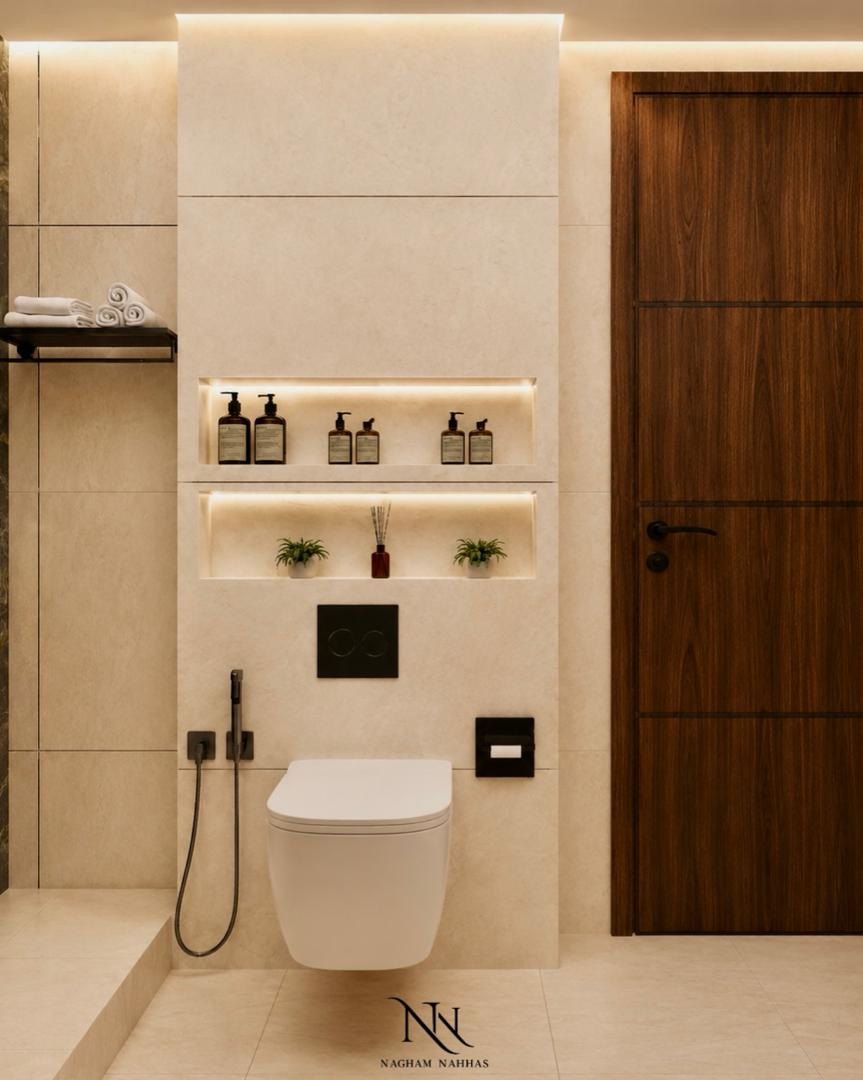 Stone bathroom wall with two lit niches holding bottles and small plants