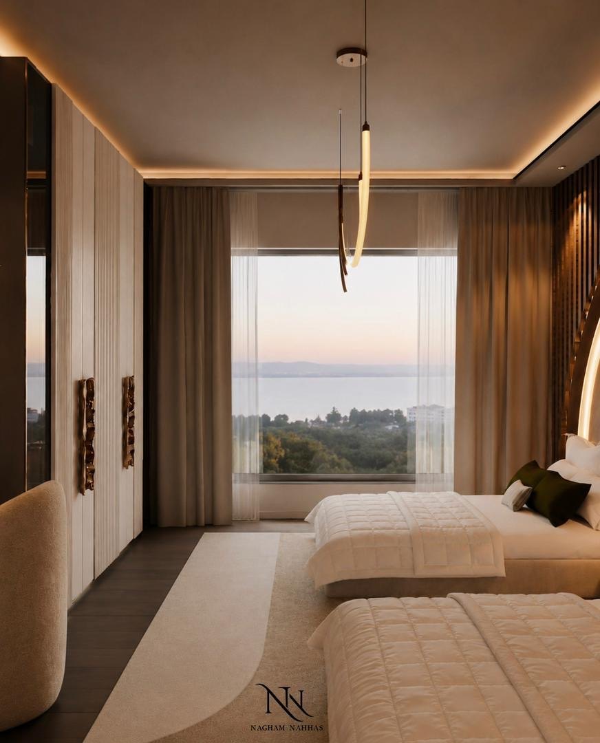 Twin bedroom opening onto a full-height window with a sunset view over the water